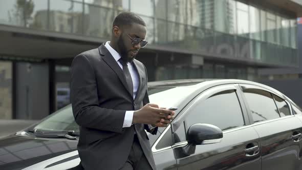 Rich Afro-American Man Waiting for Partners Near Office Building to Do Business alt