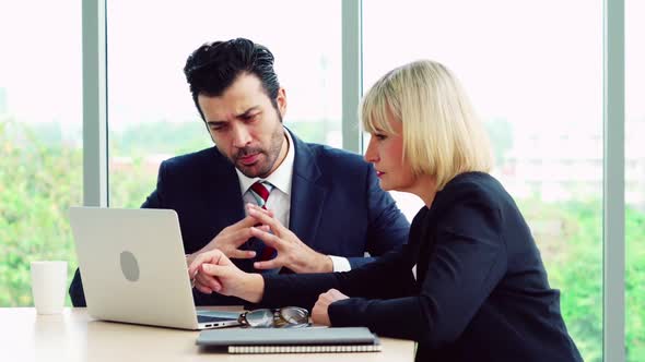 Two Business People Talk Project Strategy at Office alt