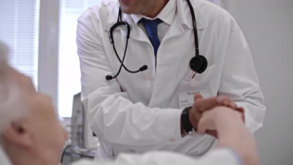 Doctor Supporting Patient in Hospital Ward alt