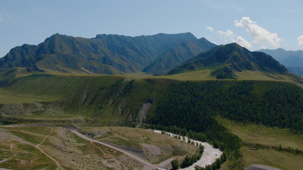 Green mountains of Altai and river under clear blue sky