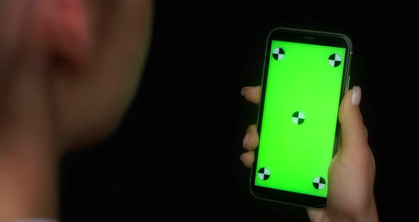 Woman Using Mobile App on Green Screen Phone Pokes at the Bottom of the Screen