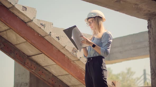 Constructor Inspect High Voltage Tower. Engineer In Hard Hat Maintenance Electricity Transmission. alt