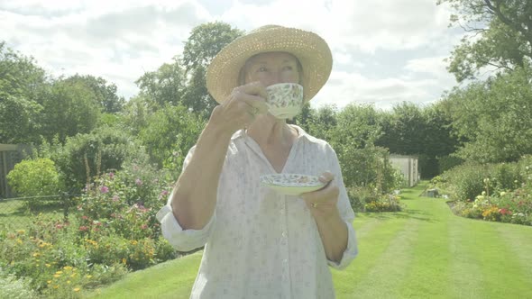 Senior Caucasian Woman Drinking Tea in Her Garden