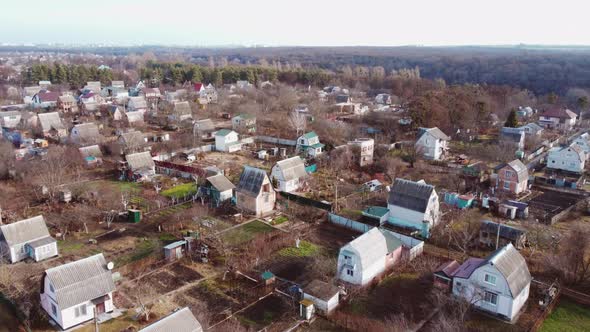 Aerial Drone View Flight Over Small Brick Houses with Plot of Land in the Middle alt