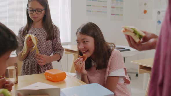 Laughing Schoolchildren Enjoying Lunch on Break alt