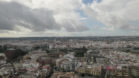 Seville cityscape panoramic view, flying towards Guadalquivir riverside, Andalusia. Spain