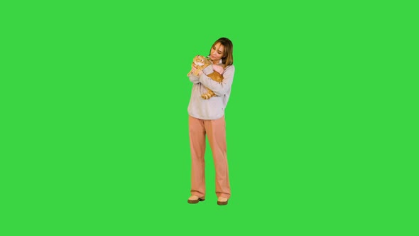 Beautiful Woman Smiling and Hugging Her Cat on a Green Screen Chroma Key