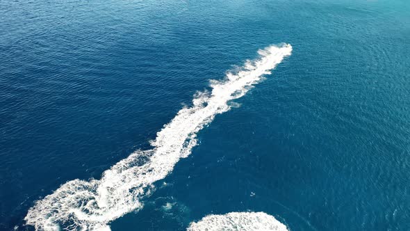 Aerial View of a Jet Ski Boat in a Deep Blue Colored Sea. Spinalonga Island, Crete, Greece