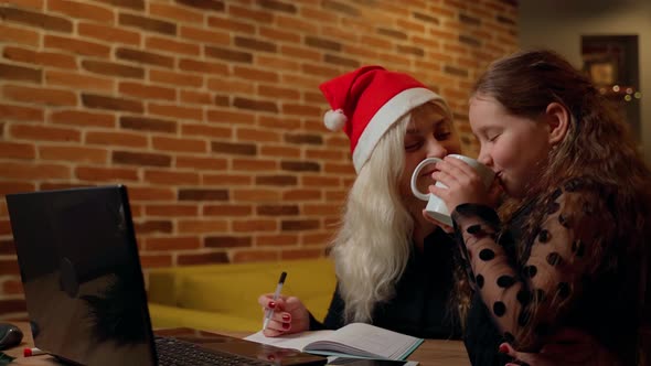Females spending time together on christmas at living room indoors. Child and adult woman alt