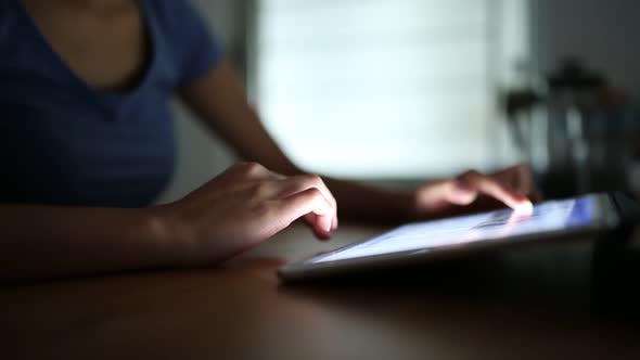 Woman using digital tablet computer at home