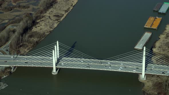 Aerial scene of traffic on Pitt River Bridge and lodging boats on river bank alt