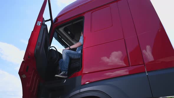 Professional Semi Truck Driver Behind the Wheel alt