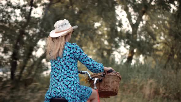 Female Cycling On Bike. Cyclist Happy Woman On Bicycle. Hair Blowing When Girl Cycling. Fun Sport. alt