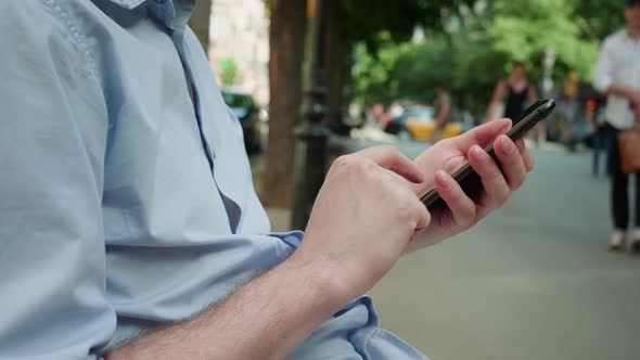 Young Man Tourist Using Smartphone Closeup Businessman Writing Message in Phone Standing in Street alt