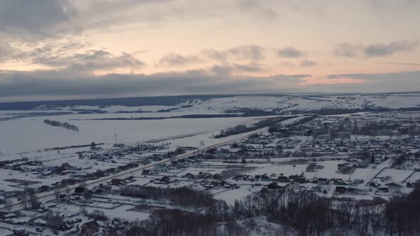 Russian Village in Winter Under a Bright Cloudy Sky