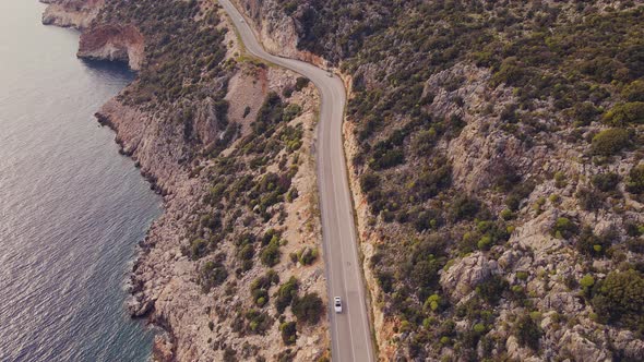 Aerial view of Coast Highway between sea and rocks alt