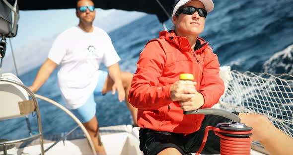 Attractive Strong Woman Sailing with Her Boat