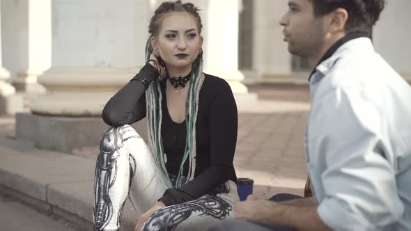Portrait of Slim Beautiful Goth Woman Sitting with Man on Urban Stairs alt