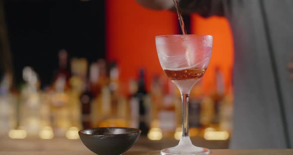 Bartender Pours Mixed Drink From the Shaker to the Frozed Highstemmed Glass Barman Makes Cocktail alt