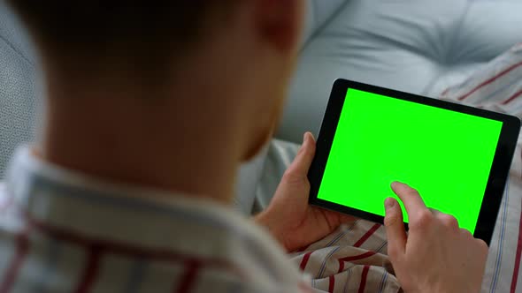 Businessman Touching Green Tablet Computer Screen at Remote Home Office Closeup alt