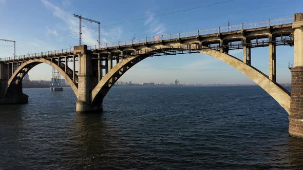 Aerial View Under the Old Arch Railway Bridge in Dnipro City alt
