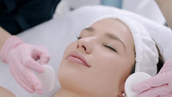 Cropped View of Cosmetologist Cleansing Woman's Skin with Pads alt