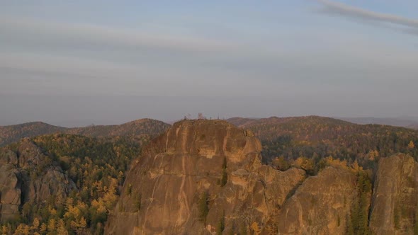 Aerial Timelapse of High Syenitic Rocks in Autumn Forest at Sunset.