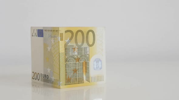 Putting roof on house Euro banknotes concept slow-mo video