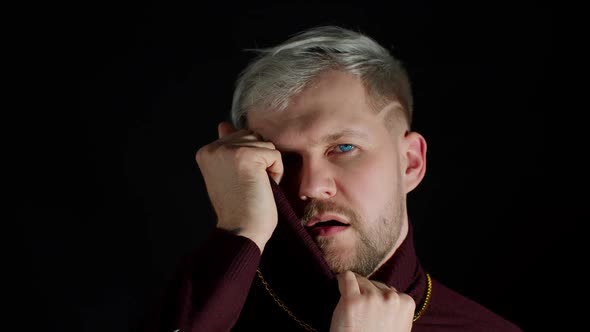 Stylish Man with Blue Eyes in Trendy Clothes Looking at Camera Feeling Happiness Fun Enjoyment alt