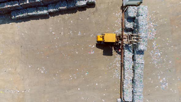 Forklift is Evacuating the Plastic Plastic Recycling Waste Bales  alt
