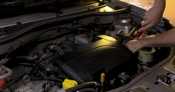 Maintenance on the vehicle, fixing the engine, tightening screws. mechanical workshop alt