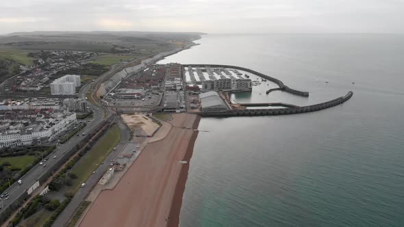 Aerial footage of Brighton and Hove town centre beach and coastal area showing the Brighton Marina alt