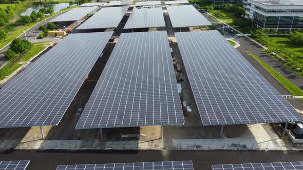Solar panels installed in a corporate office complex parking lot and solar panels on the office comp alt