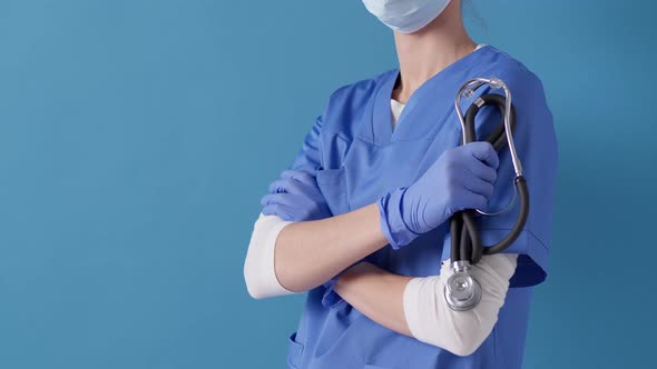 Nurse holding stethoscope while standing with her arms crossed at work. Ready to check your health