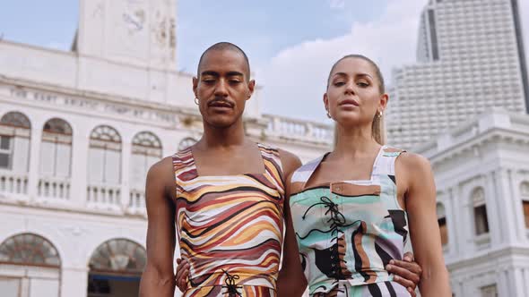 Fashion Models Arm In Arm Together In Brightly Coloured Clothing alt