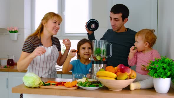 The Family Prepares Smoothies at Home alt