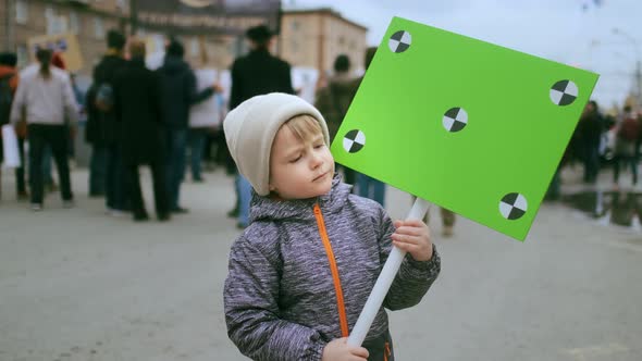 Playful Boy Kid Jumps with Chromakey Greenscreen Banner