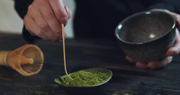 Man Add Matcha Green Tea Powder Into Bowl. Matcha Organic Green Tea. Matcha Tea Ceremony. Close Up