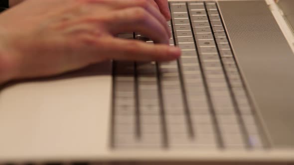 Male Hands Typing on Keyboard Man Using Laptop in Home Office