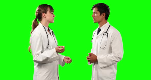 Side view of doctors discussing with green screen alt