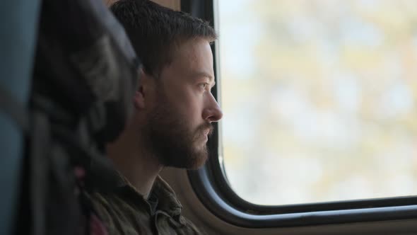 A man looking through the train window