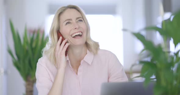 Laughing businesswoman talking on the phone