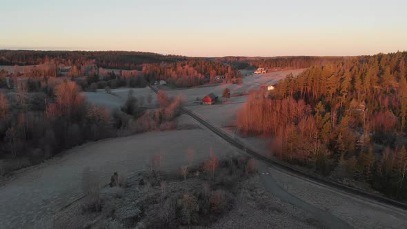 Road Leading Up to Red Farm Barn Forest Landscape Early Morning Aerial