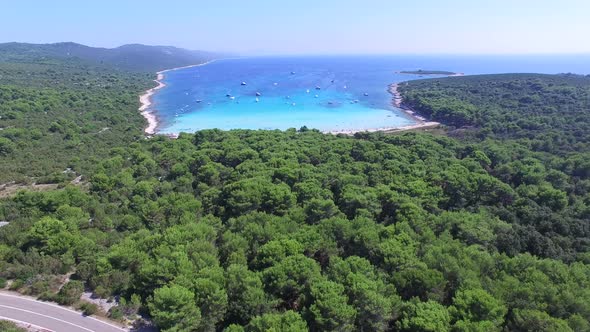 Aerial view of boats in a beautiful azure lagoon with highway in the foreground alt