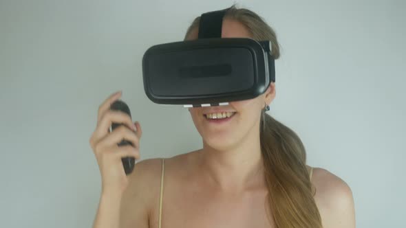 Beautiful Young Girl In A Virtual Reality Helmet Playing A Game
