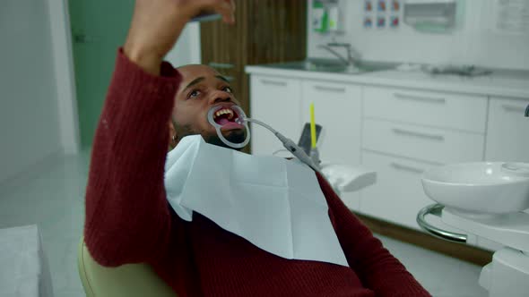 Guy with Dental Expander in His Mouth Makes Selfie alt