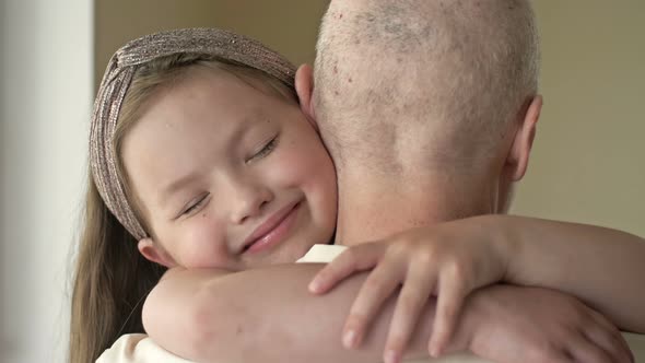 Little Girl Hugs Her Relative with Cancer alt