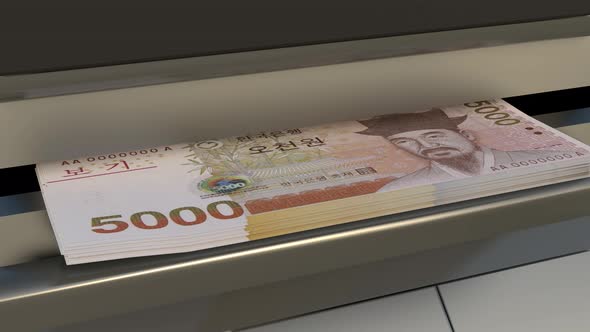 5000 South Korean won in cash dispenser. Withdrawal of cash from an ATM. alt