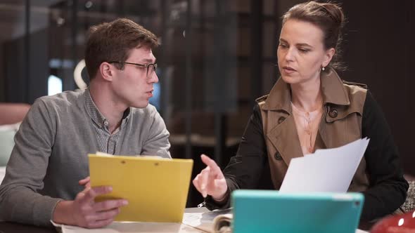 Concentrated Man and Woman Discussing Sale and Purchase Agreement in Furniture Shop Indoors alt