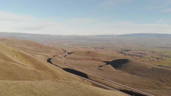 flying towards a highway from the hill alt